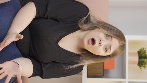 Vertical-video-of-Woman-looking-at-camera-confused.